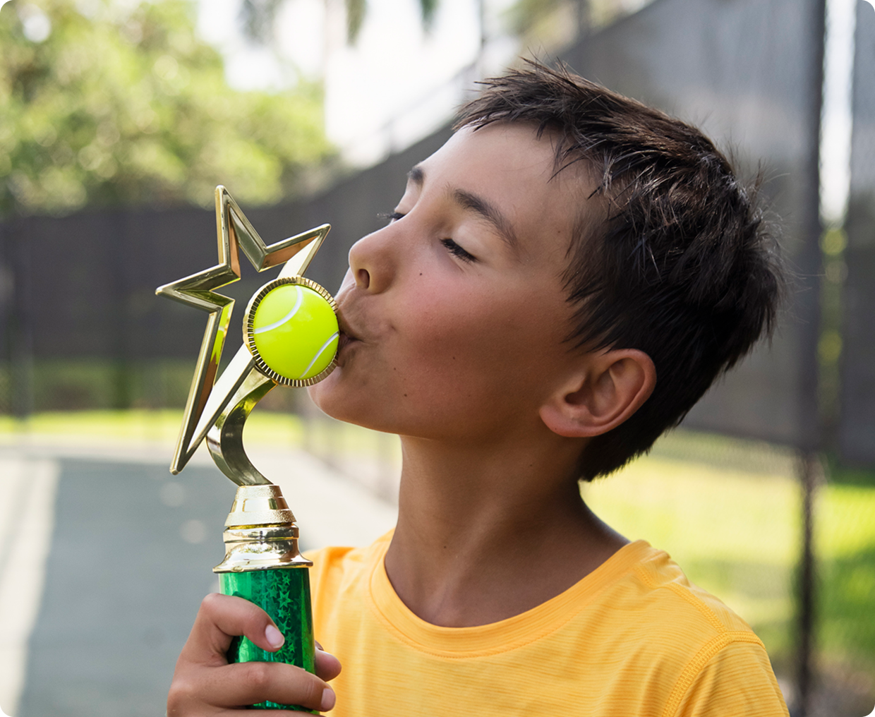 Young tennis player with trophy