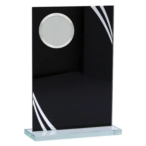 Black rectangular trophy with silver circular plate and white lines on a glass base.