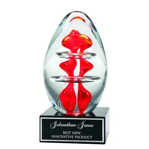 A clear glass award with a red design inside and a black base.
