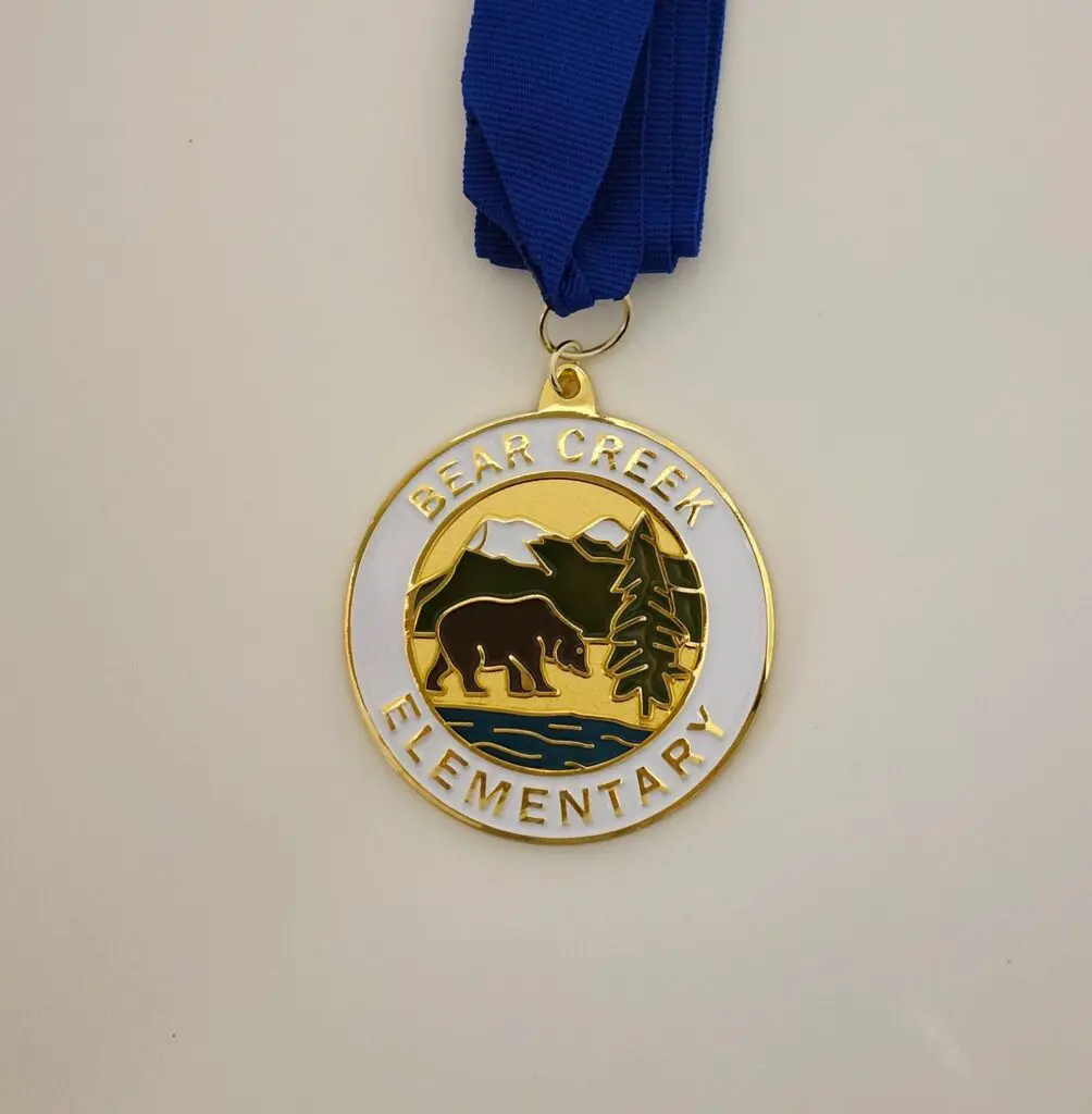 Gold medal with a buffalo design, labeled 'Elementary'.