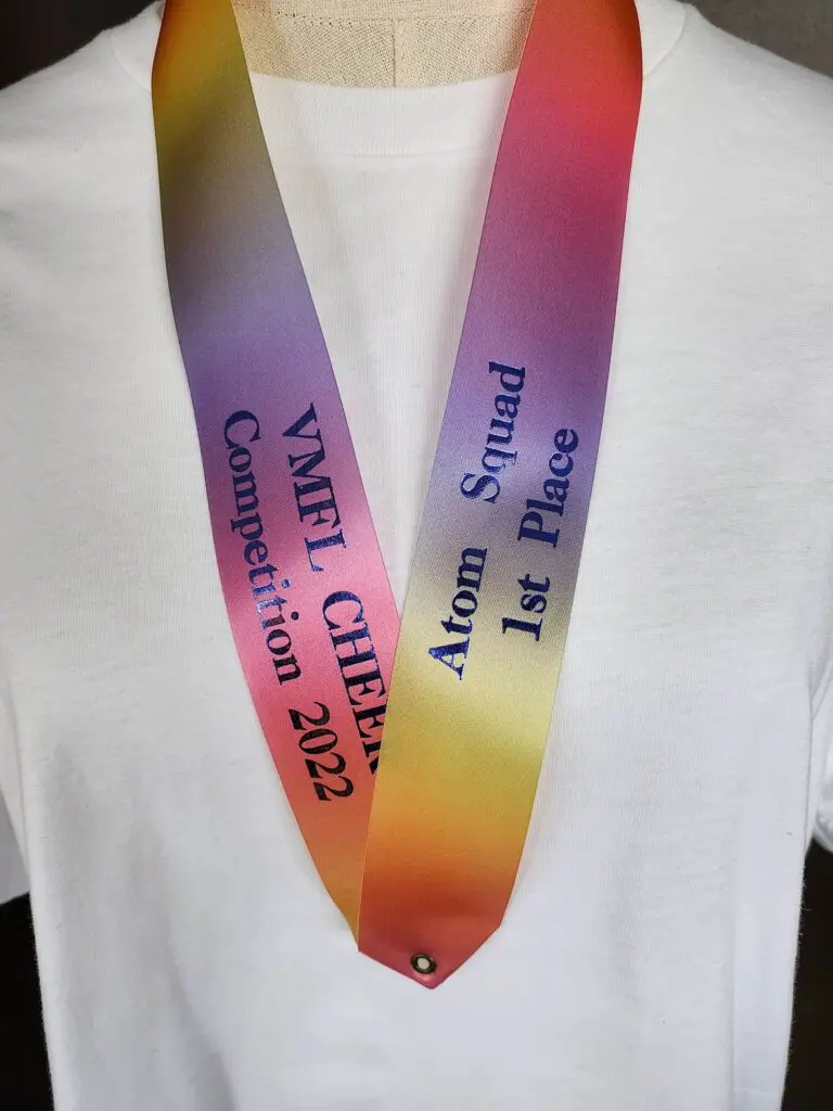 A colorful medal with inscriptions for a 2023 event in Vietnam.