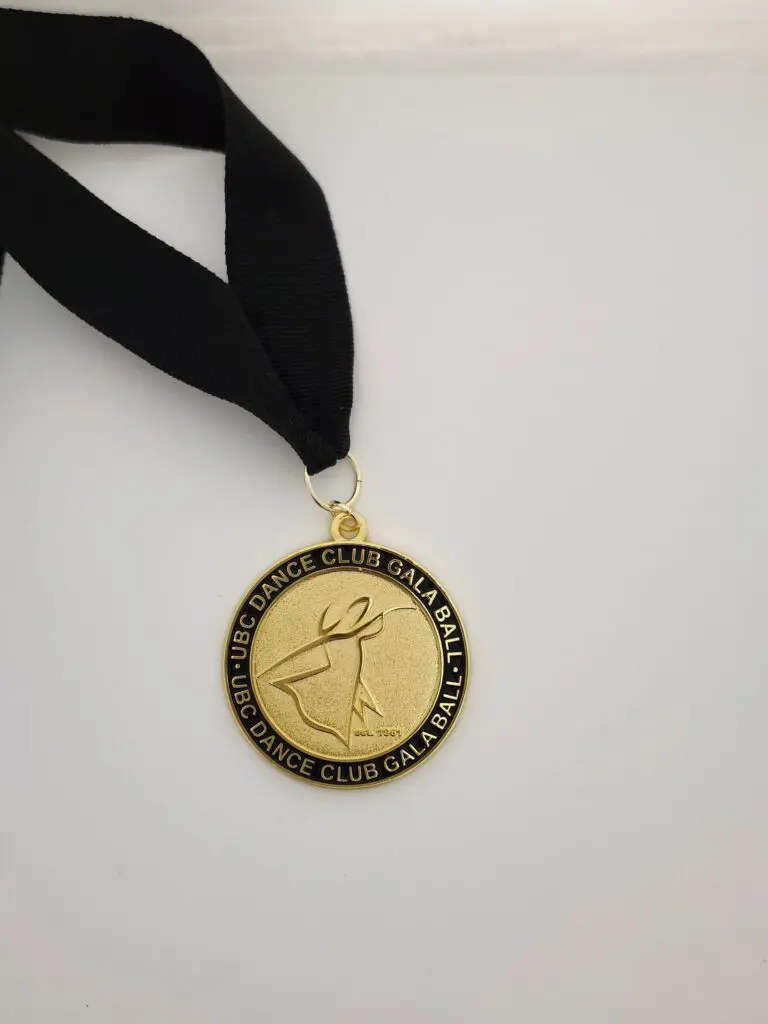 Gold medal with black ribbon awarded for excellence in cultural heritage.