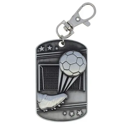 A metallic keychain with a soccer ball and goal design.