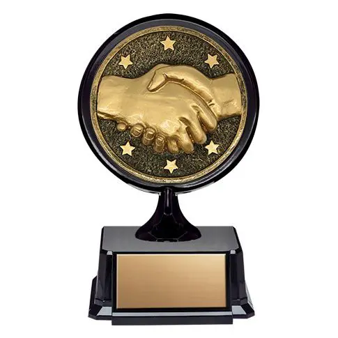 A handshake trophy with a gold plaque on a black base.